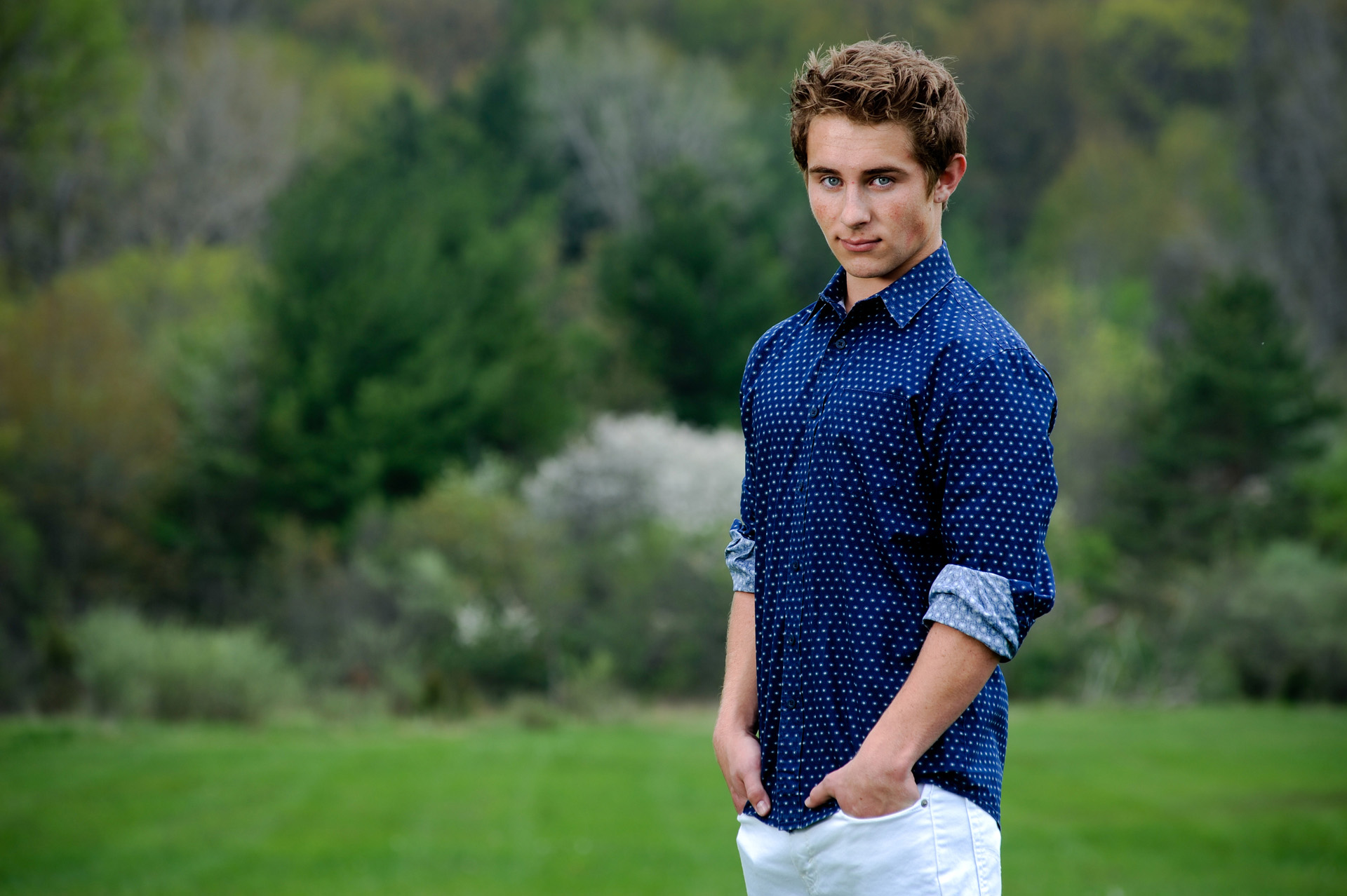 Troy , Michigan senior photographer shows a high school senior standing out in nature during his senior shoot.